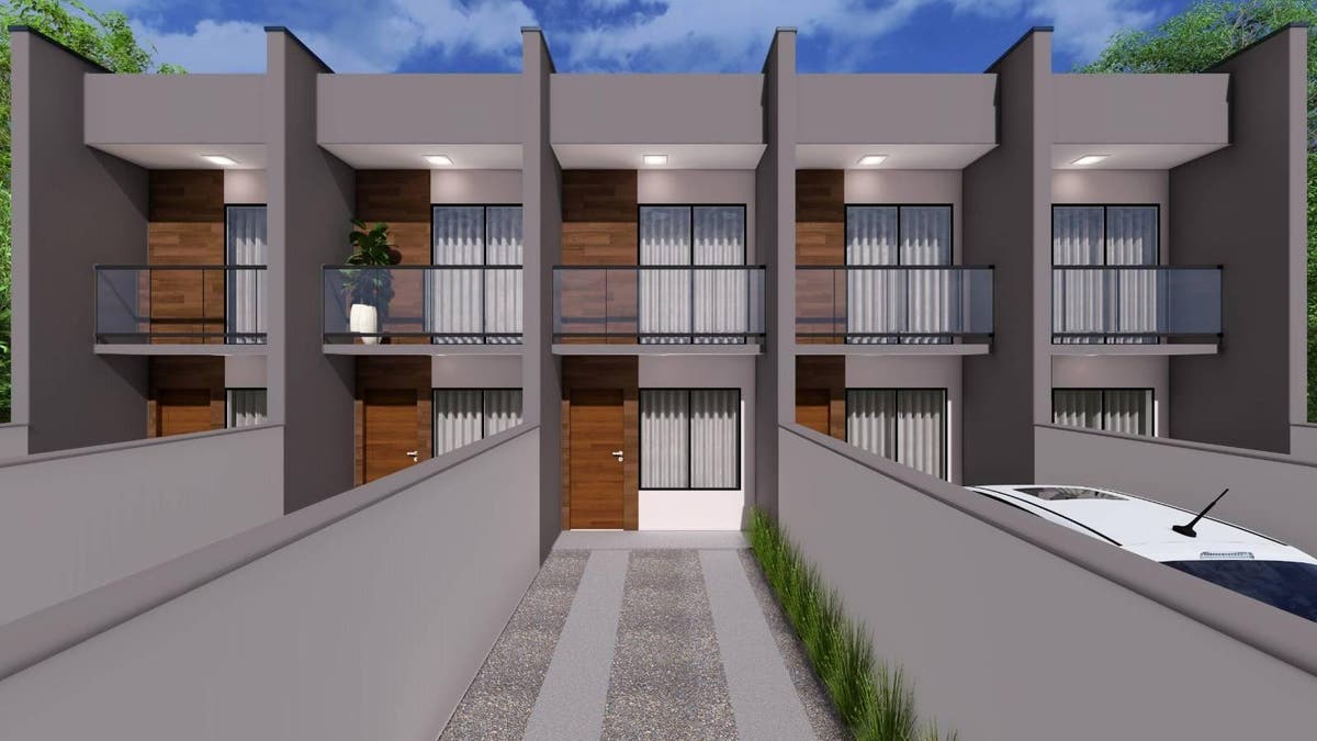 Prédio residencial de dois andares com fachada moderna de concreto e vidro.